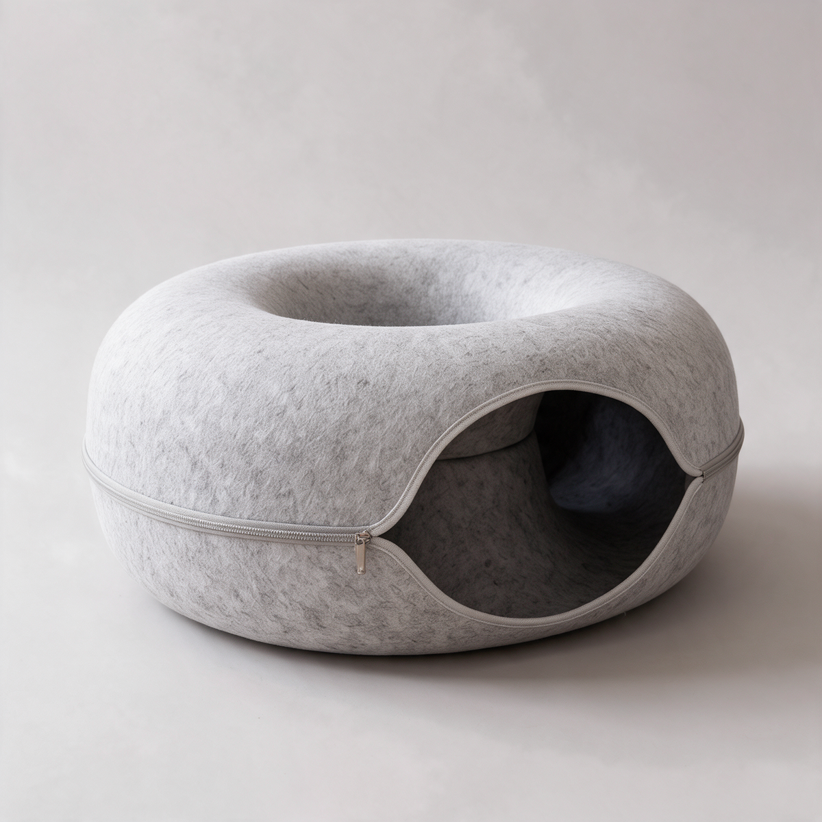 The Tunnel felt cat bed and tunnel on a plain background, showing the donut shape and side opening
