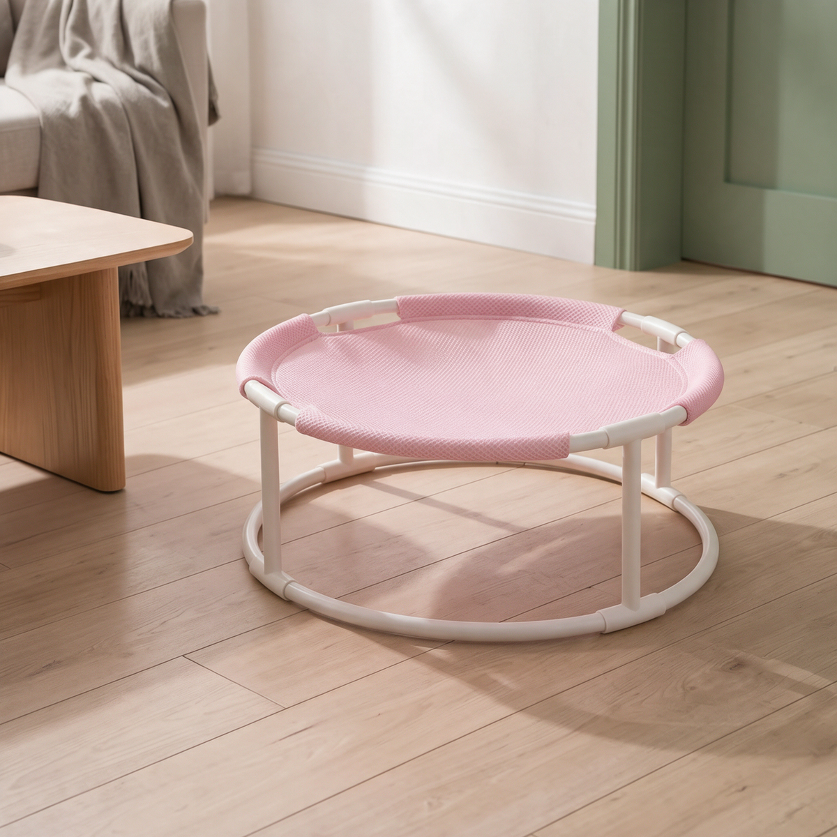 Close view of The Perch elevated cat hammock showing the pink sling fabric and the white metal frame